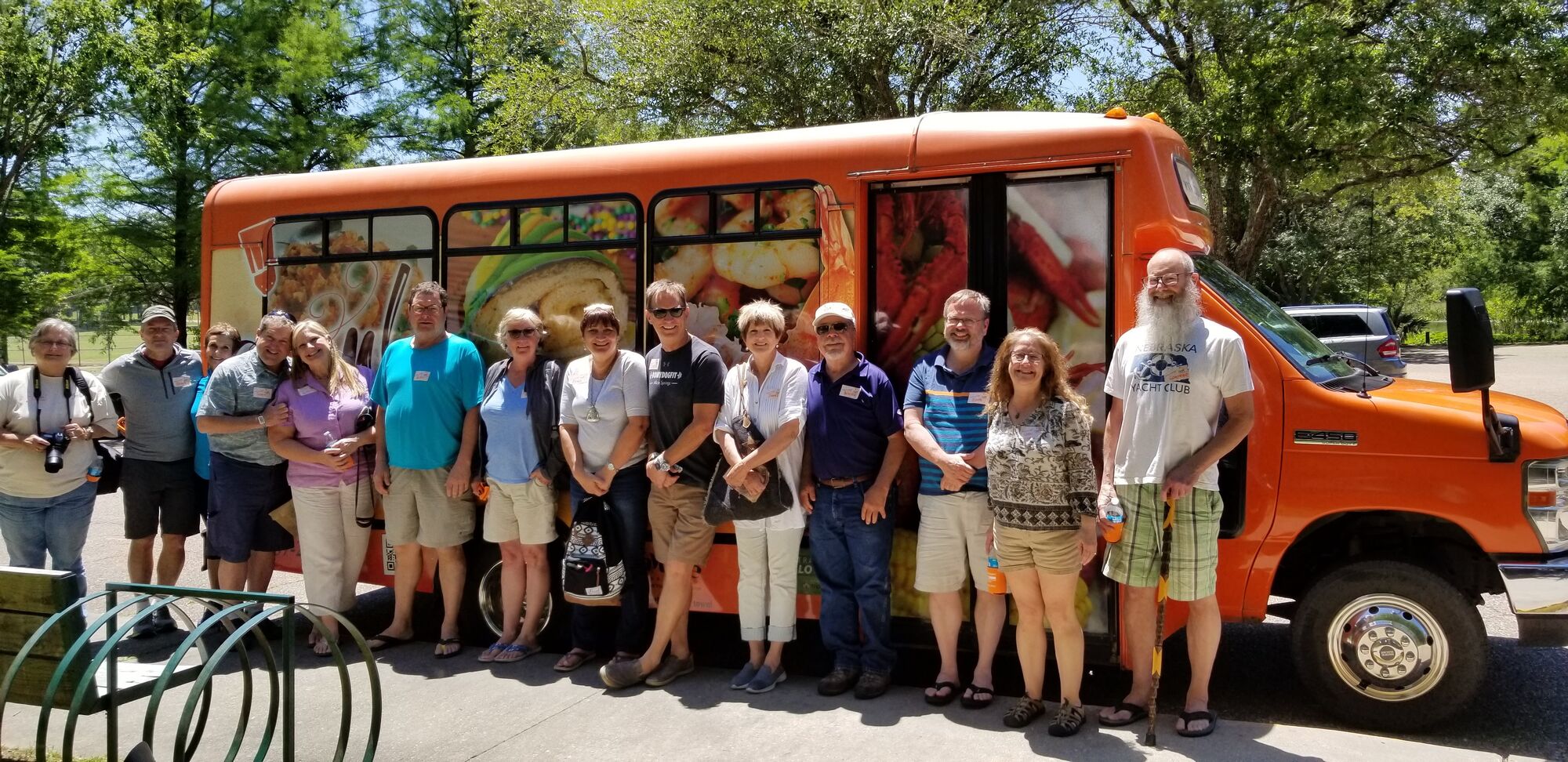 a group of people standing in front of a bus